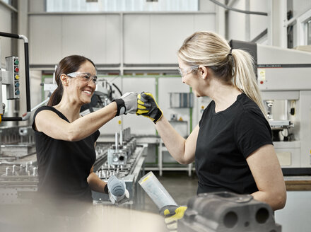 Two woman at work, fist bump - CVF01158