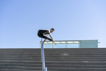 Businessman crossing banister in the city - AFVF02851