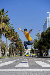 Spain, Barcelona, man in the city jumping on the street - AFVF02884