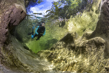 Austria, Salzkammergut, river Weissenbach, female scuba diver in a wild mountain river - YRF00213