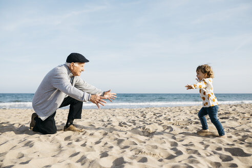 Grandfather playing with his granddaughter on the beach - JRFF03217