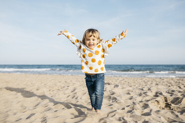 Portrait of happy little girl running on the beach - JRFF03227