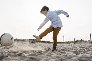Kleiner Junge spielt Fußball am Strand und kickt den Ball - JRFF03238