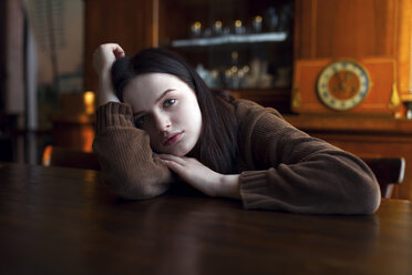 Depressed Caucasian girl leaning on table - BLEF02071