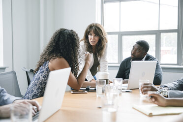 Business people using laptop in meeting - BLEF02098