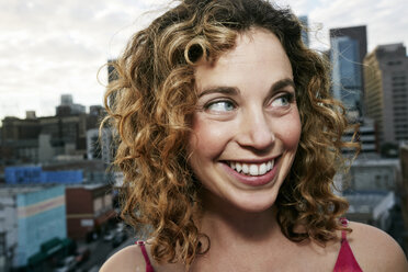 Portrait of smiling Caucasian woman on urban rooftop - BLEF02115