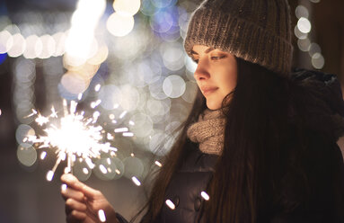 Caucasian woman holding sparkler - BLEF02134