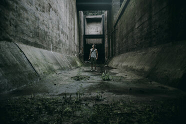 Caucasian man standing in concrete alley - BLEF02273