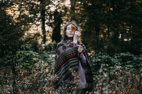 Caucasian woman holding autumn leaf - BLEF02274