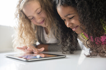 Smiling girls using digital tablet - BLEF02295