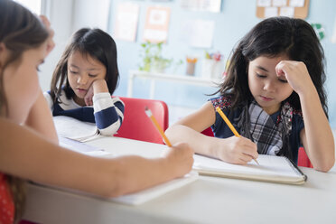 Girls writing in notebooks in school - BLEF02355