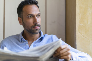 Portrait of businessman reading newspaper - DIGF06951