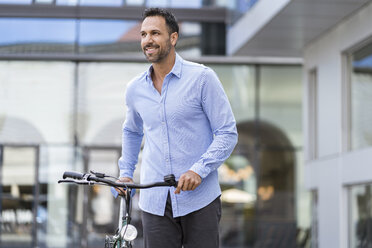 Geschäftsmann mit Fahrrad in der Stadt - DIGF06960