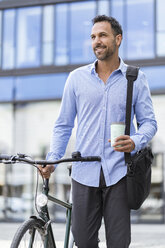 Businessman with bicycle on the go in the city - DIGF06965
