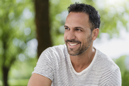 Portrait of smiling man in a park - DIGF06999