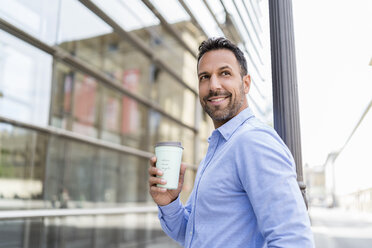 Portrait of smiling businessman with takeaway coffee in the city - DIGF07006