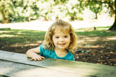 Portrait of Caucasian preschool girl at picnic table - BLEF02481