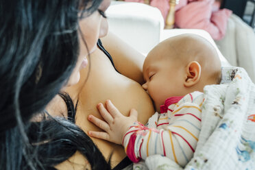 Mother breast-feeding baby daughter - BLEF02489