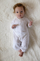 Portrait of Caucasian baby boy laying on white fur blanket - BLEF02586
