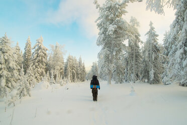 Caucasian man standing in snowy forest - BLEF02675