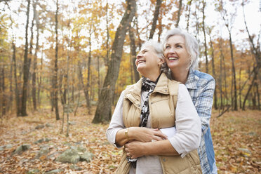 Caucasian women hugging outdoors in autumn - BLEF02718