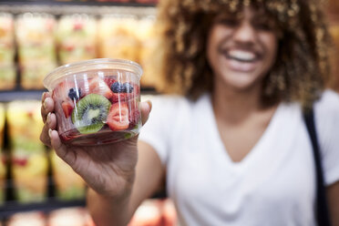 Black woman cup of fruit salad in grocery store - BLEF02819