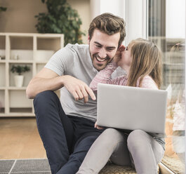 Young man and little girl surfing the net together - UUF17355