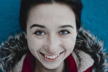 Smiling Caucasian woman near blue wall - BLEF02979