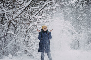 Snow falling on Caucasian woman in forest - BLEF02991