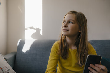 Girl on couch at home with cell phone - KNSF05829