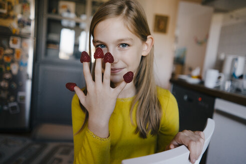 Portrait of a girl with raspberries on her fingertips - KNSF05858