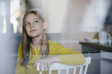 Portrait of a girl sitting on chair at home looking up - KNSF05862