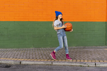 Young girl playing basketball, laughing - ERRF01242