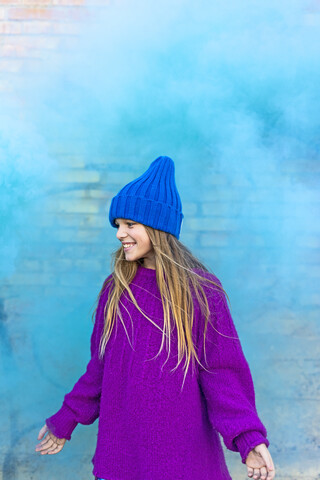 Young girl with turquoise color powder in the background stock photo