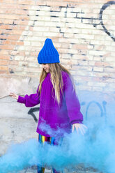 Young girl with turquoise color powder in the background - ERRF01267