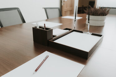 Ballpen and paper on conference table in office - AHSF00308