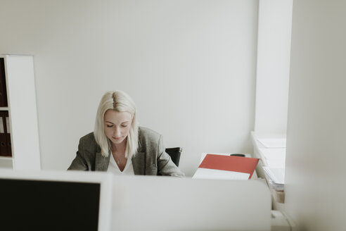 Young woman working at desk in office - AHSF00322