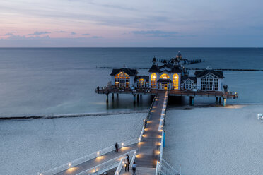 Traditional pier illuminated at sunset, elevated view, Sellin, Rugen, Mecklenburg-Vorpommern, Germany - CUF50936
