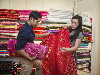 Chinese man and woman shopping for fabric - BLEF03061