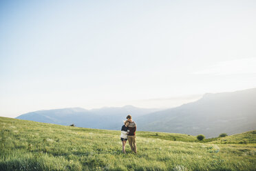 Caucasian couple hugging in field - BLEF03132