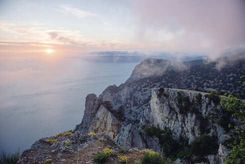 Sunrise from foggy ocean cliff - BLEF03154