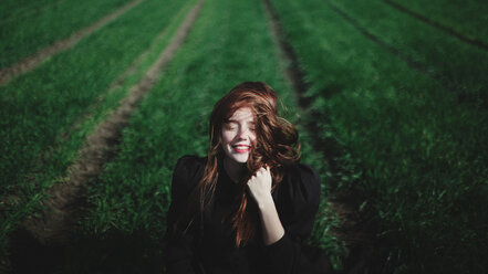 Smiling Caucasian woman in rows of grass - BLEF03241