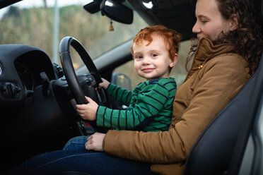 Mother and son at steering wheel of car - CUF51173