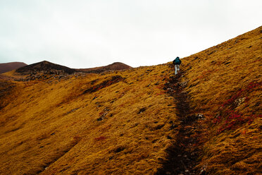 Tourist hiking up hill, Reykjavík, Gullbringusysla, Iceland - CUF51218