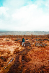 Tourist walking on autumn landscape,Londrangar, Snaefellnes Westfjords, Iceland - CUF51240