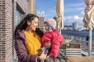 Mother and daughter by river, Berlin, Germany - CUF51272