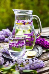 Jar with glass of water with lilac sirup and lemon - SARF04261