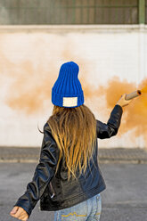 Back view of girl with orange smoke torch - ERRF01283