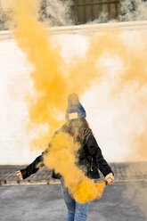 Back view of girl with orange smoke torch - ERRF01284