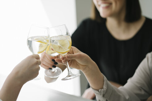 Nahaufnahme von drei Frauen, die Gläser mit Wasser anstoßen - AHSF00349